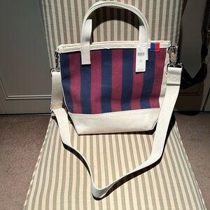 Kule striped canvas bucket bag in red and navy and cream, with cross body strap.